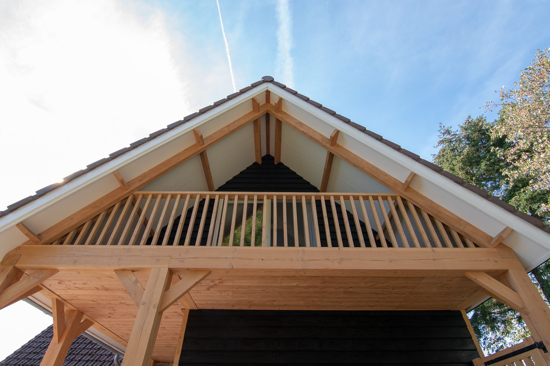 Houten aanbouw aan een woning met balkon